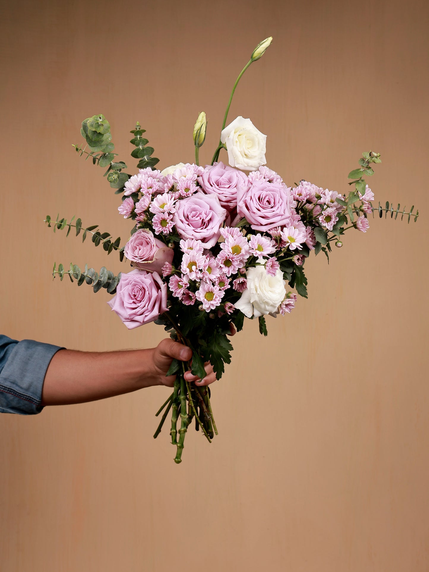 pink flowers in hand with white eustoma and filler