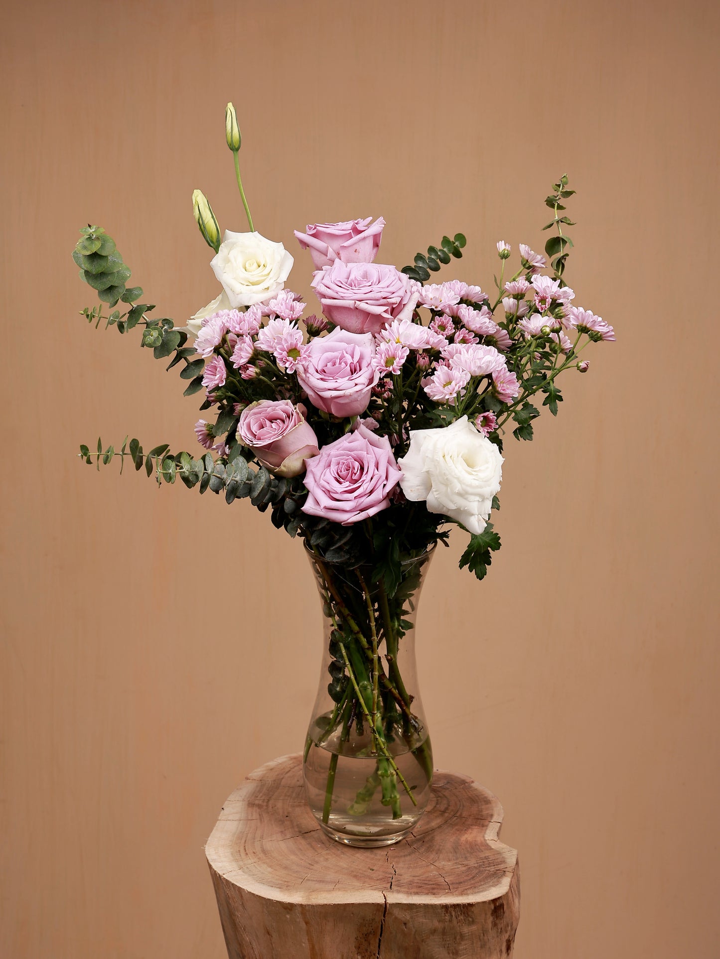 pink flowers with white eustomas in glass vase