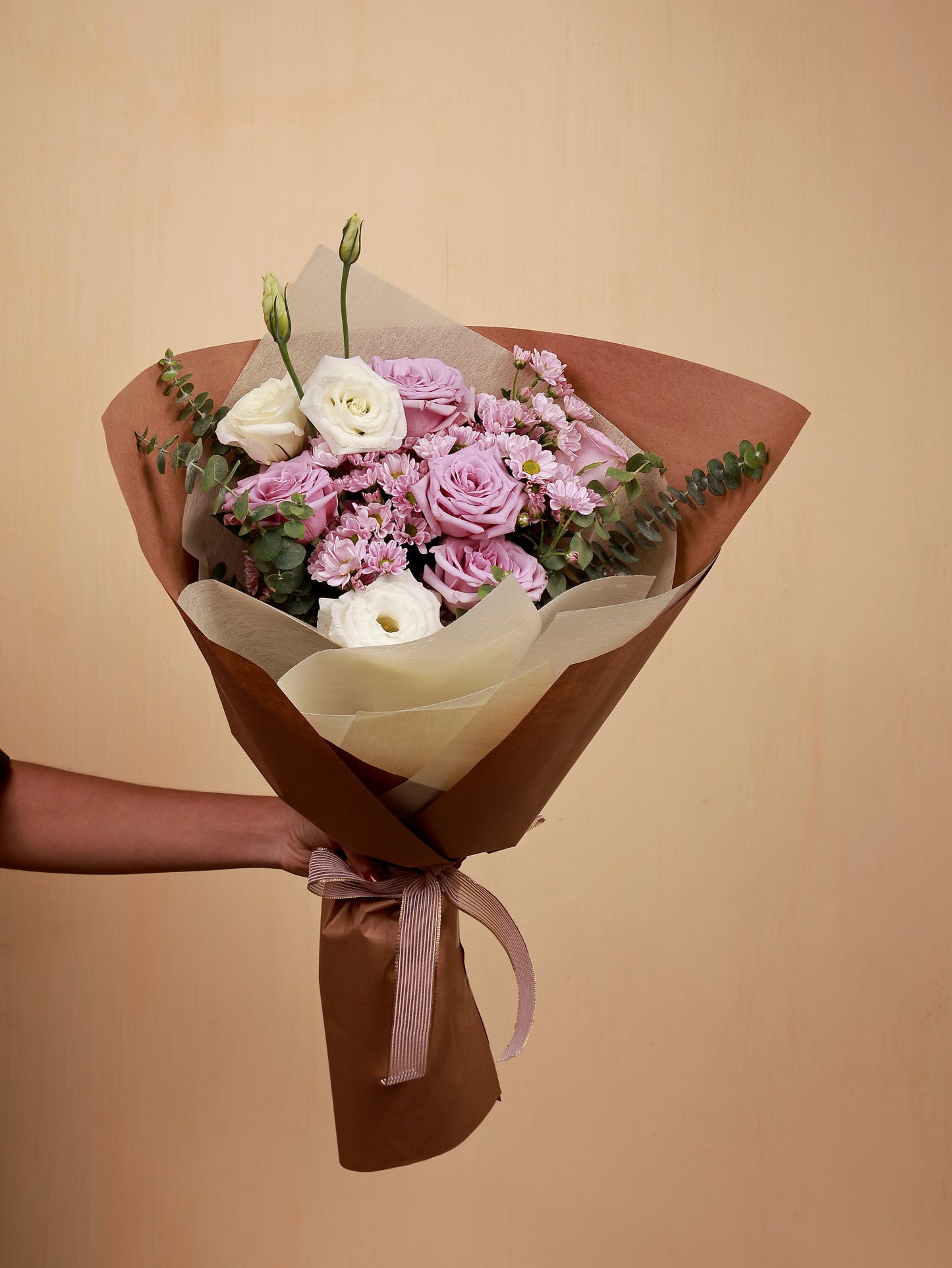 A pink flower bouquet with white Eustoma and eucalyptus
