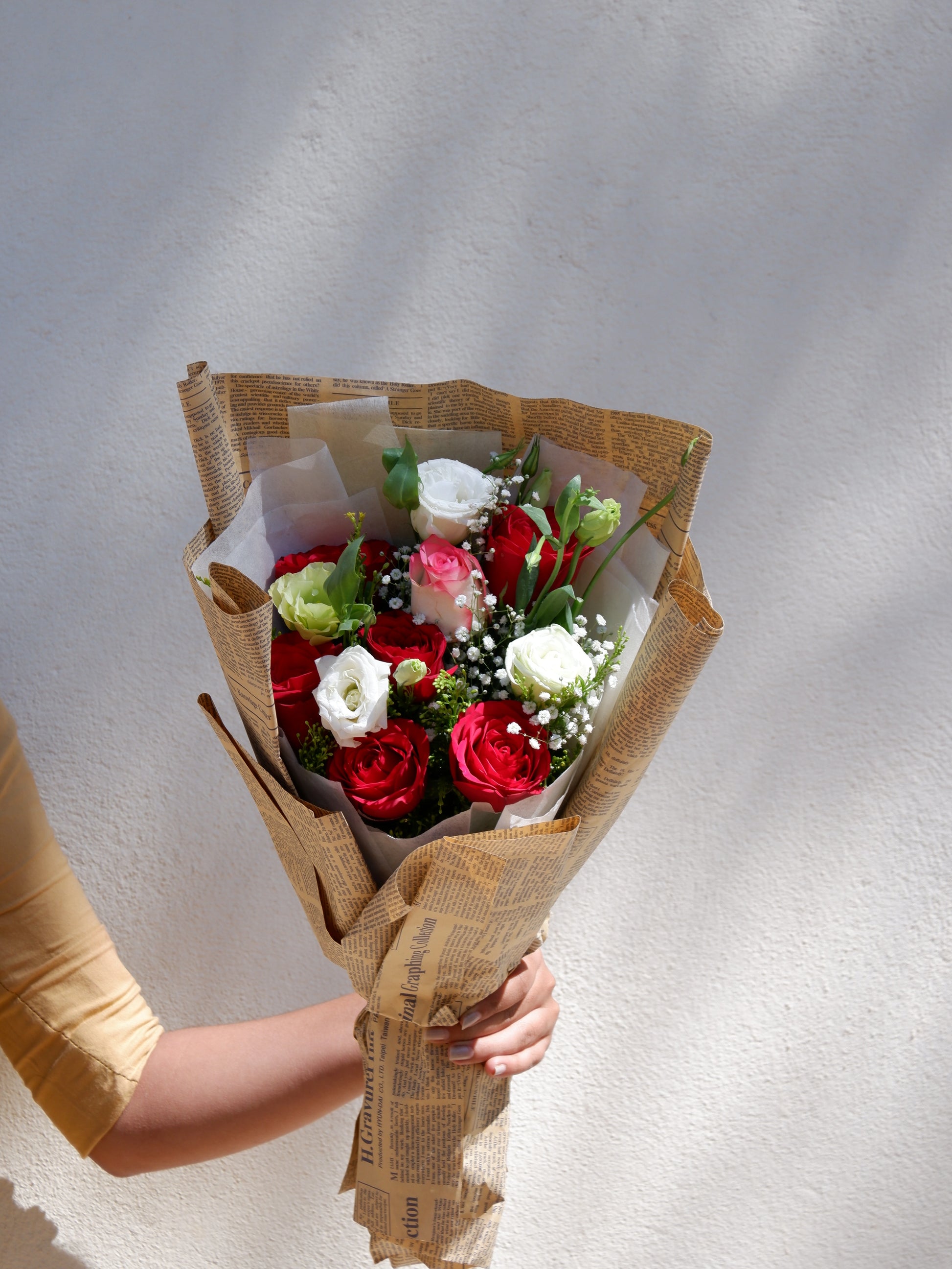 A lovely bouquet in newspaper style wrapper