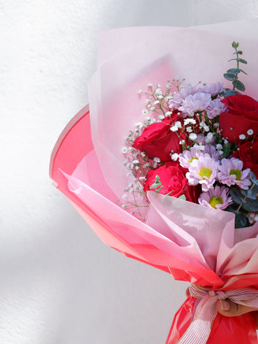 Sun kissed bouquet of red rose with pink santini