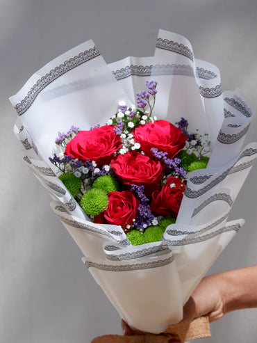Red rose and green button closeup