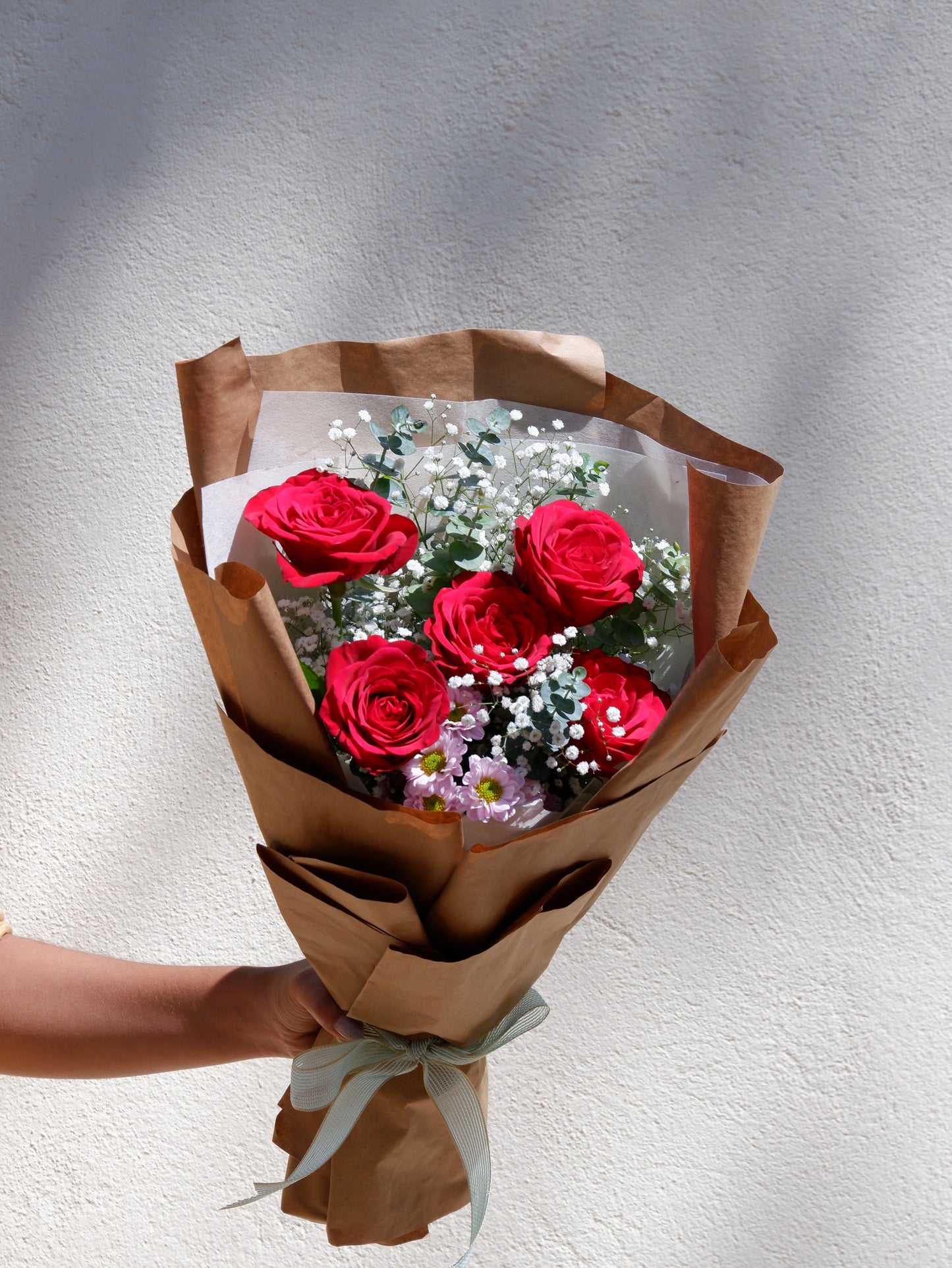 Red rose bouquet with brown paper wrap