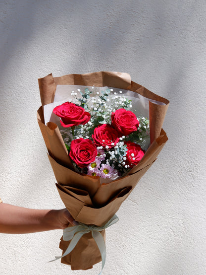 Red rose bouquet with brown paper wrap