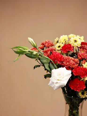 closeup of white eustoma and red carnations with santinis