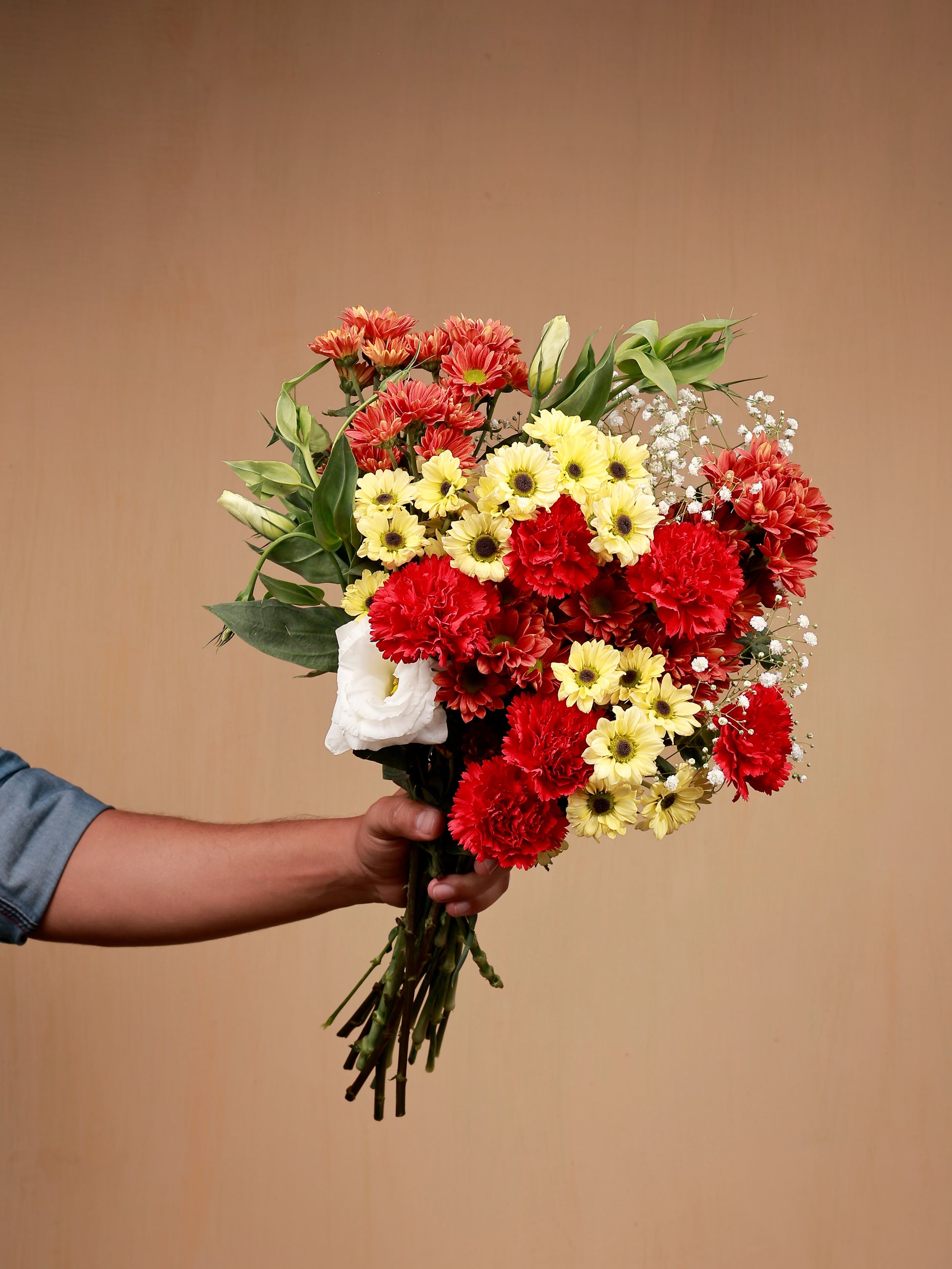 red carnations with santinis and white eustoma in hand